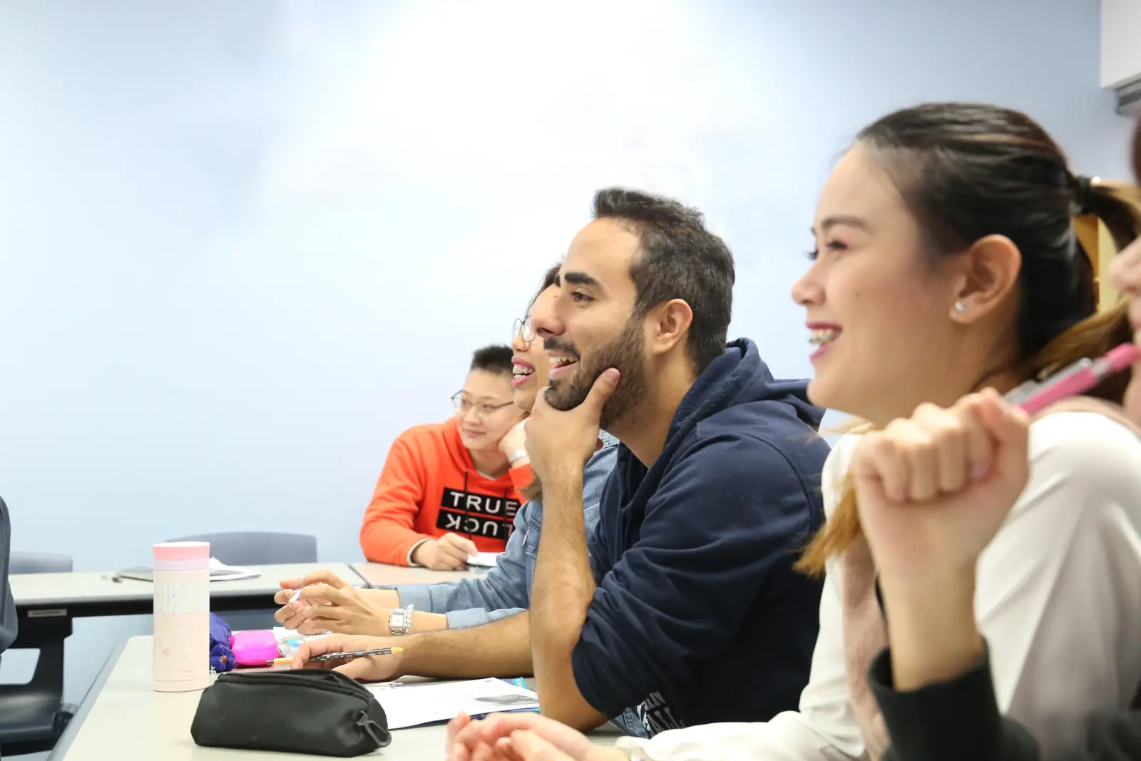 Students laughing together during a class at Aspire2 International